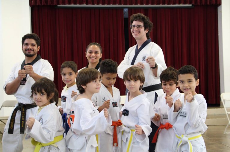 Robinson students participate in the Beyond the Bell taekwondo program, with teachers and students in their traditional uniform while in a fighting stance.